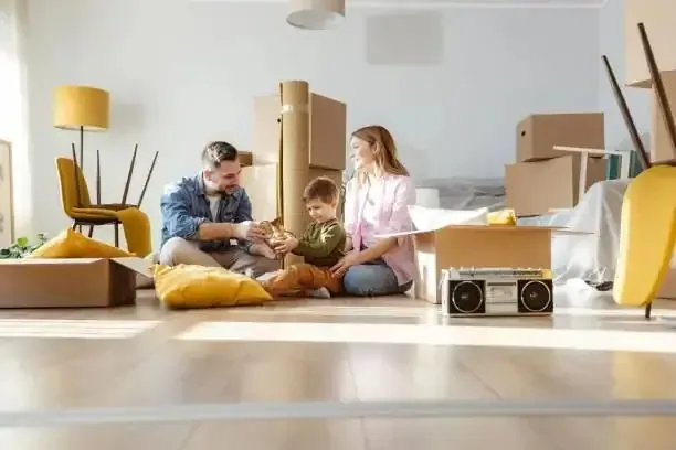 Family settling into their new Rochester home with packing boxes around them, after a move handled by Medway and Kent Removals