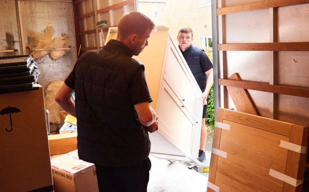 Medway and Kent Removals crew loading carefully packed boxes and wrapped furniture into the removal van
